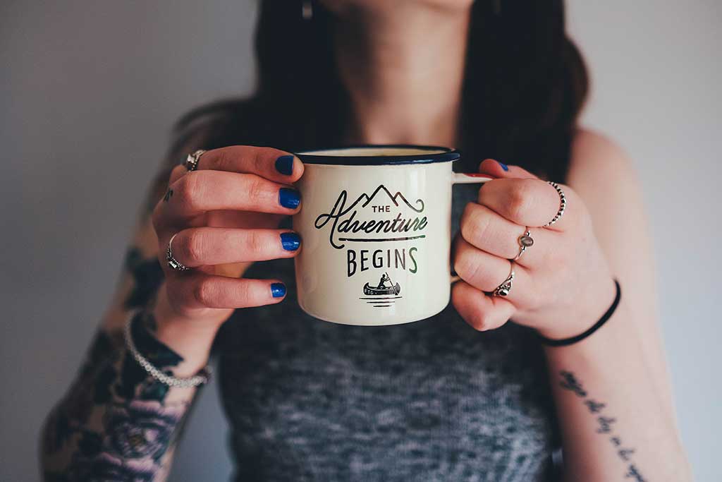 Personalized bridesmaid gift mug being held up by girl