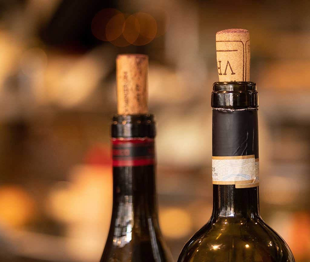 Close up of two corks in wine bottles at a wedding