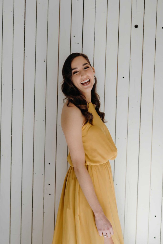 Standing and smiling back in Ivy dress